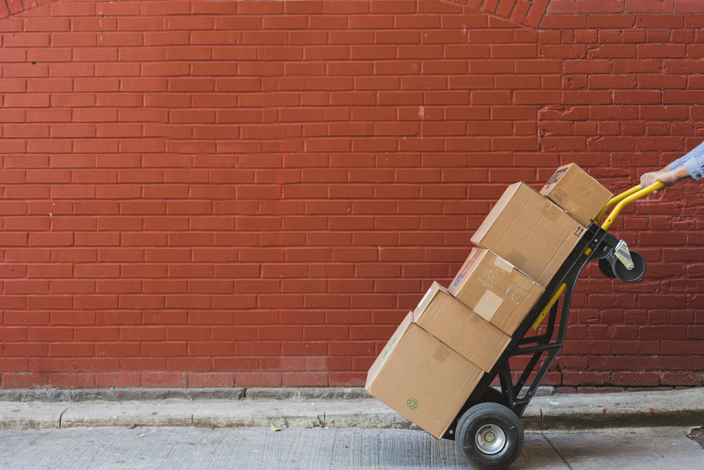 Shipping boxes in front of a red brick wall